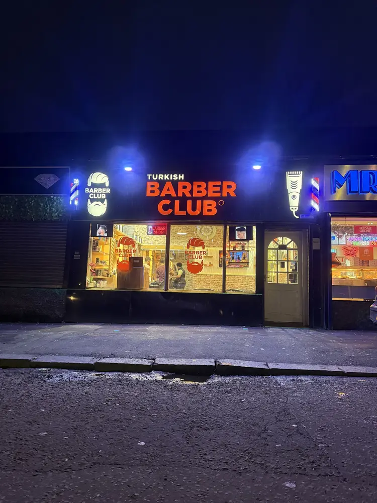 Turkish Barber Club shopfront by night